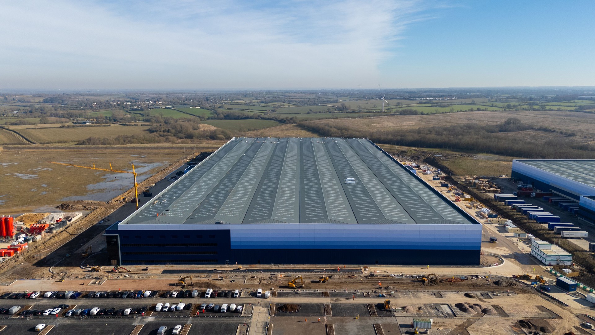 Large distribution center under construction dominating the landscape